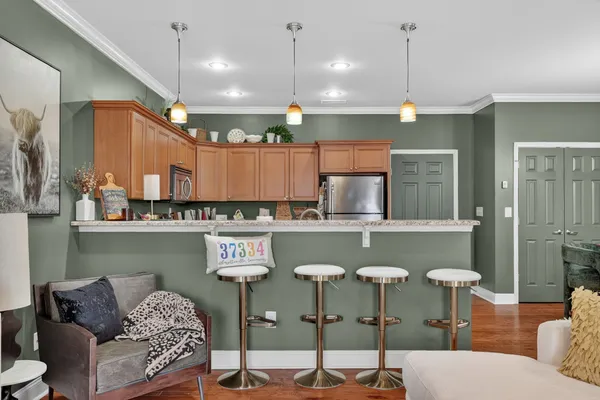 a kitchen with a table chairs stove and kitchen view