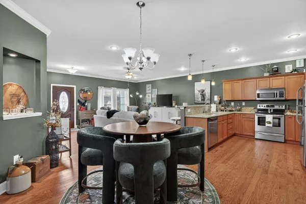 a large kitchen with a table and chairs
