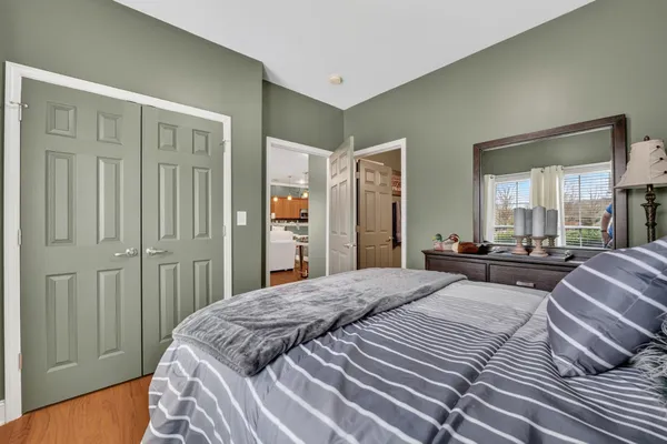 a spacious bedroom with a bed and large mirror in a bedroom