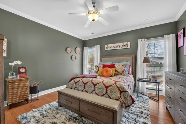 a bedroom with a bed and a chandelier