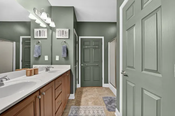 a spacious bathroom with a double vanity sink mirror and double