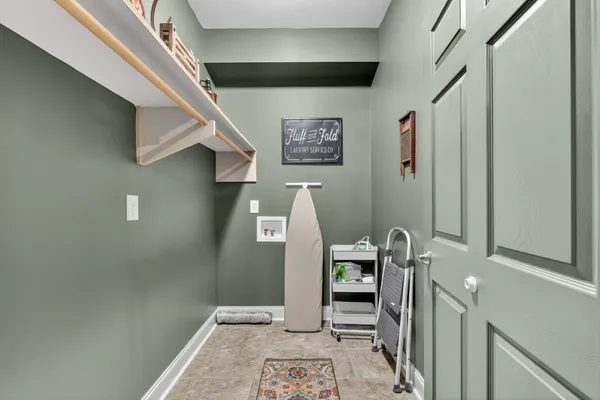 a view of an empty room with window and cabinet