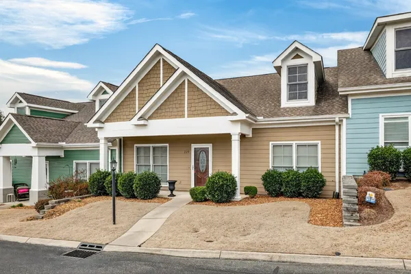 a view of a house with a yard and plants