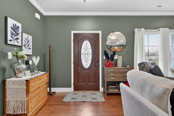 a living room with couch and wooden floor