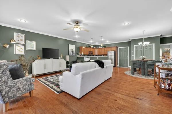 a living room with furniture and wooden floor