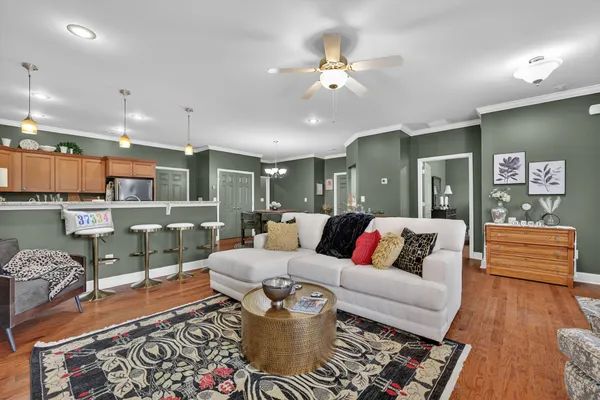 a living room with furniture and wooden floor