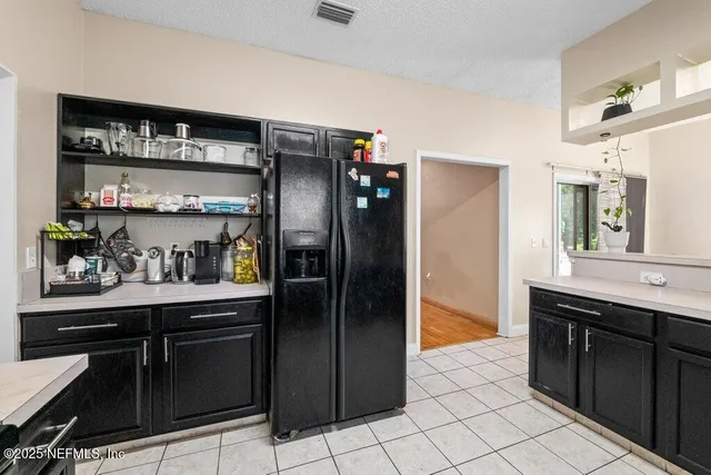 a view of a hallway with wooden floor and a bathroom