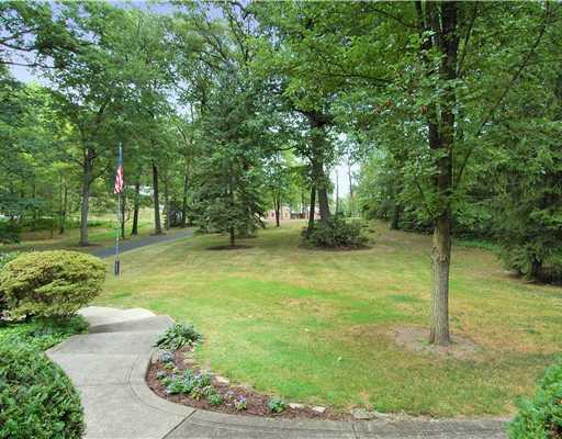 216 Woodcroft Road Economy, PA 15005 - Photo 15 of 18 Yard/Garden. This is the Deep Front Yard taken from the front of the home. Yard is Deep and Private and perfectly maintained. The driveway has multiple drains to keep water fom accumulating and coming into the garage.
