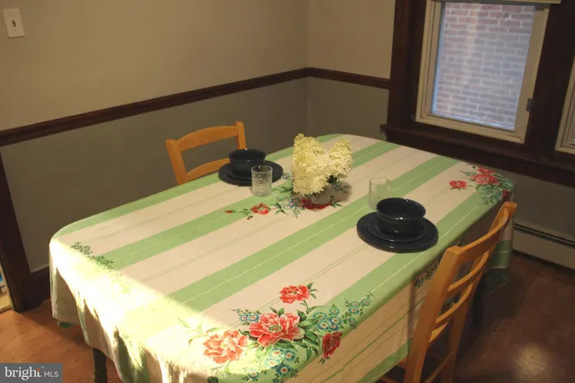 a kitchen with granite countertop white cabinets and black appliances