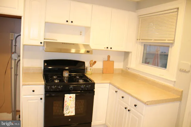 a kitchen with white cabinets and a sink