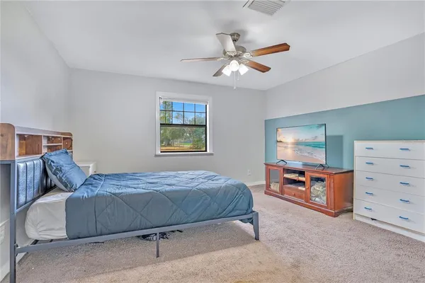 a bedroom with a bed and dresser