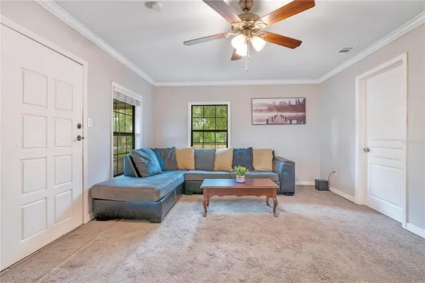 a living room with furniture and a chandelier