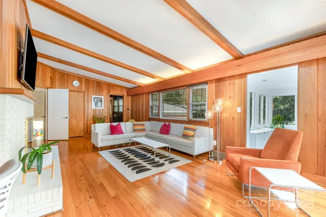 a living room with furniture and a floor to ceiling window
