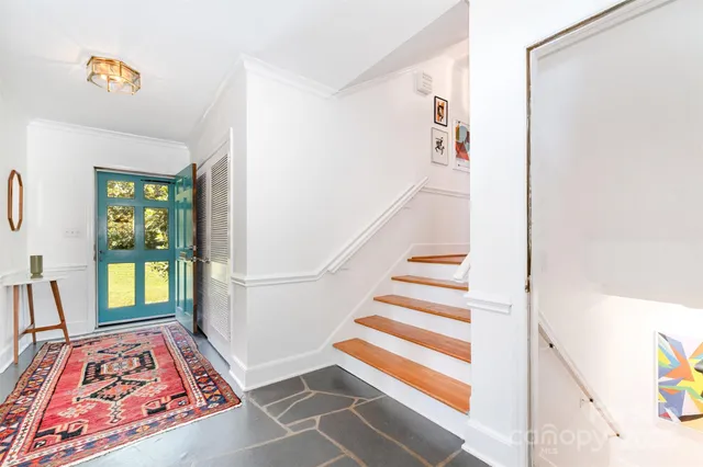 a view of entryway with a rug windows and a rug