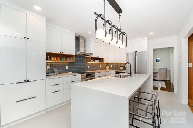 a kitchen that has a lot of cabinets in it and appliances
