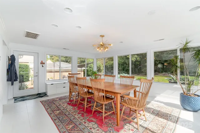 a view of a dining room with furniture wooden floor and chandelier