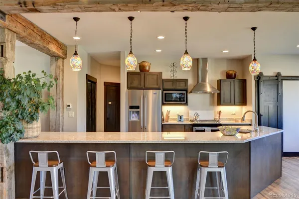 a bathroom with a sink a center island and a chandelier