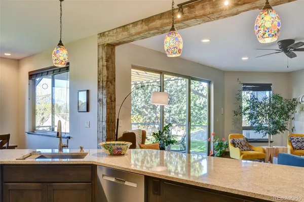 a kitchen with a chandelier sink and wooden floor