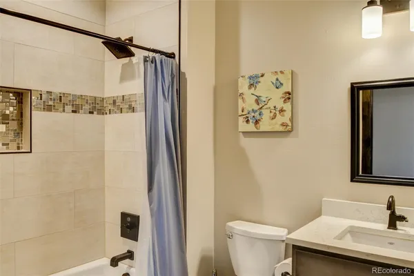 a bathroom with a sink and mirror with toilet