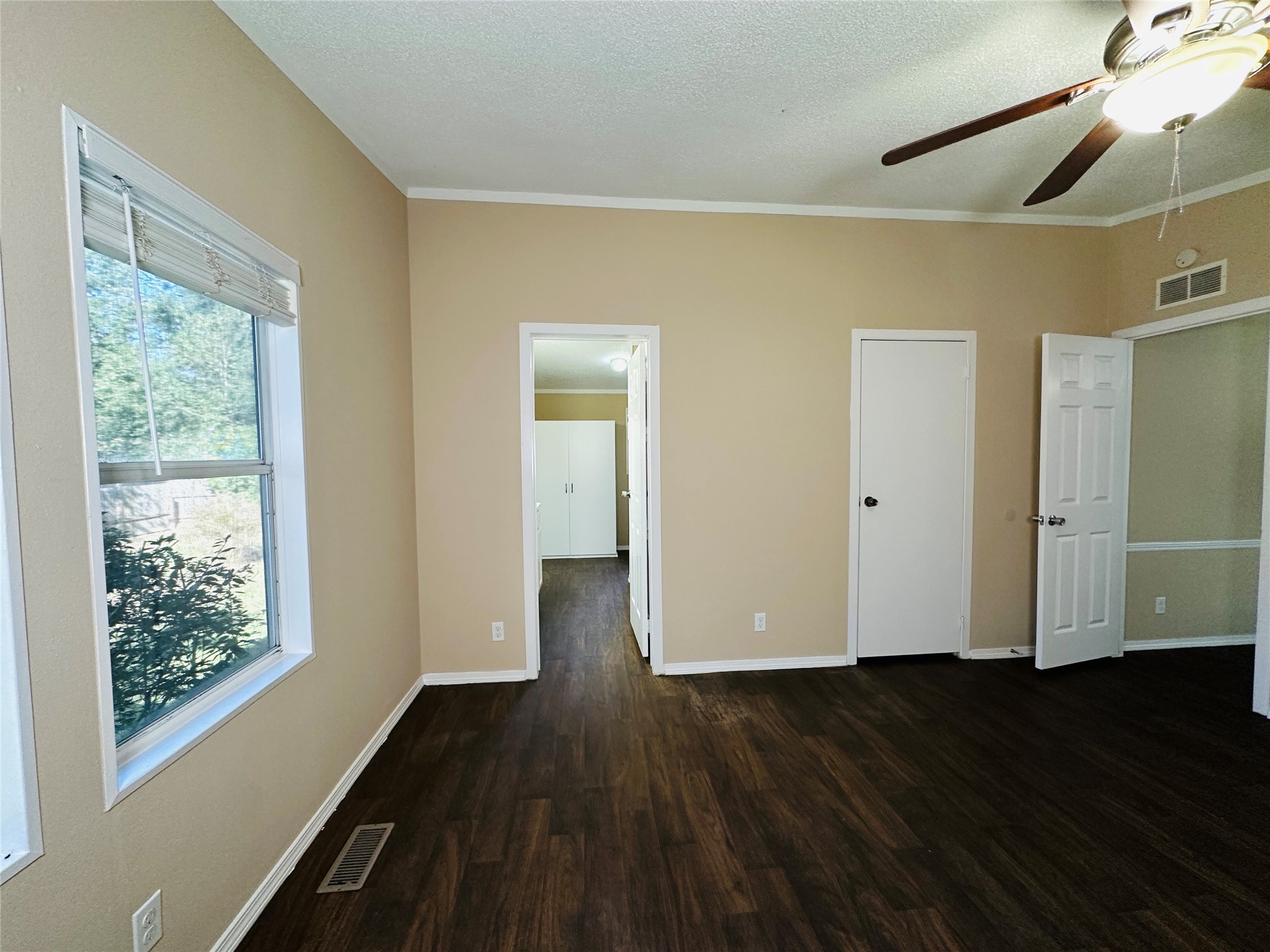 16497 Spring Rain Court Conroe, TX 77302 - Photo 11 of 18 a view of empty room with wooden floor and fan