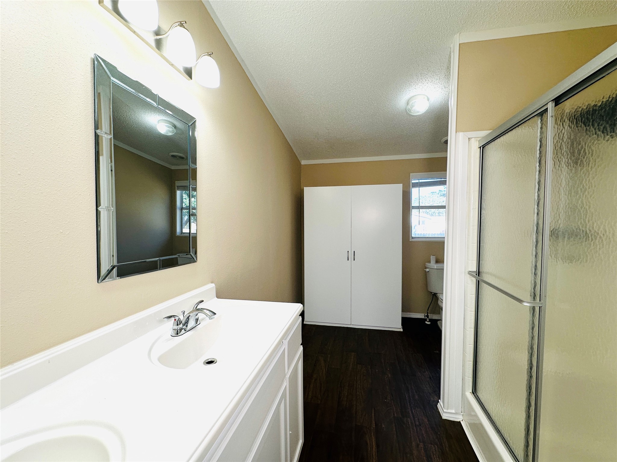 16497 Spring Rain Court Conroe, TX 77302 - Photo 12 of 18 a bathroom with a sink a mirror and a shower