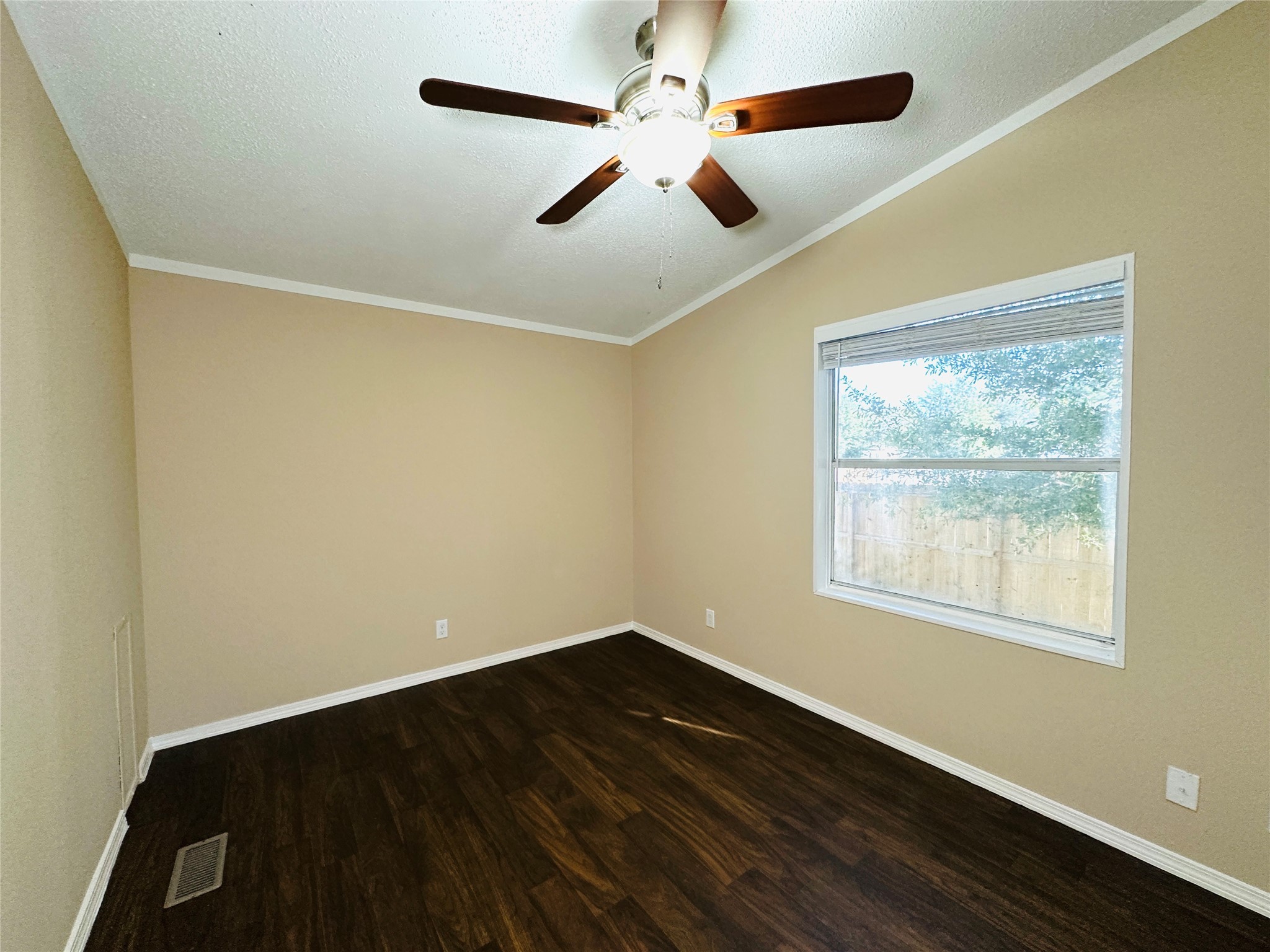 16497 Spring Rain Court Conroe, TX 77302 - Photo 16 of 18 a view of an empty room with wooden floor and a window