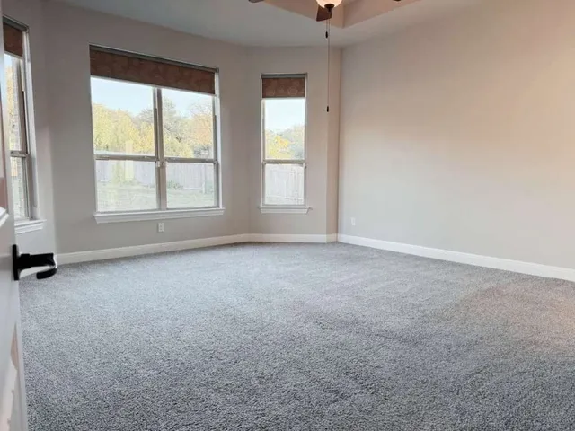 an empty room with a empty space and windows