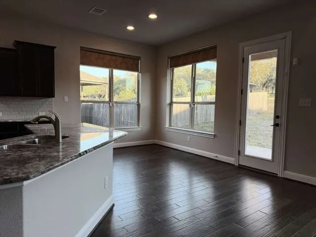 a view of a kitchen with a sink and a large window