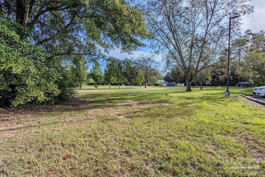 Woodbine Road Pace, FL 32571 - Photo 12 of 21 a view of a green field with wooden fence