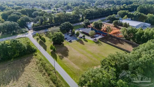 an aerial view of a house with a yard basket ball court and outdoor seating