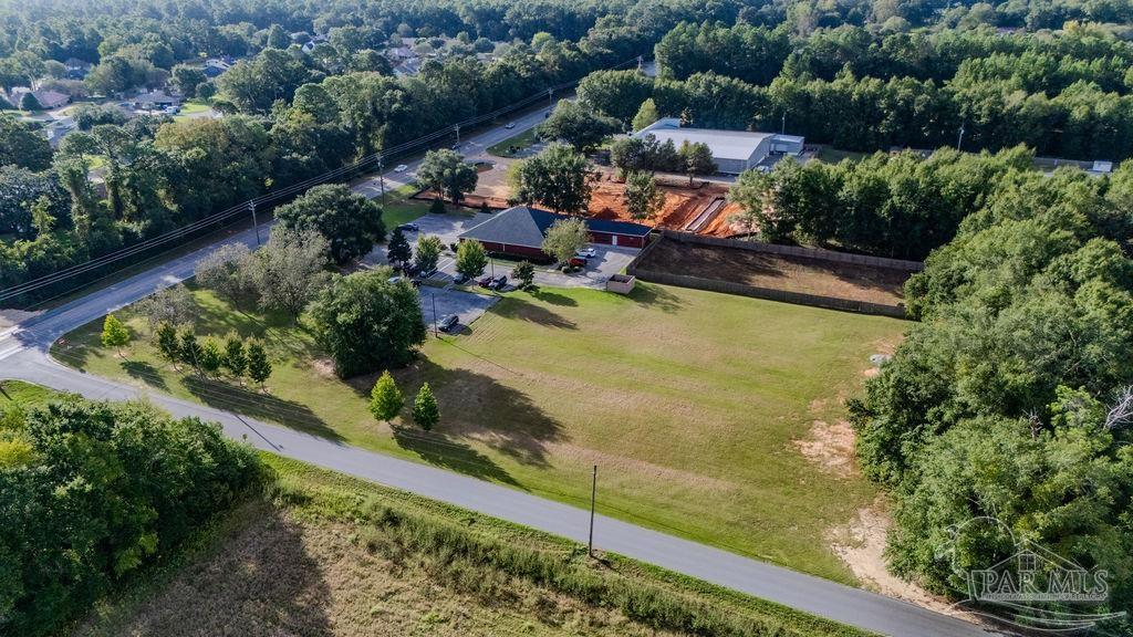 Woodbine Road Pace, FL 32571 - Photo 2 of 21 an aerial view of a house with a garden and lake view
