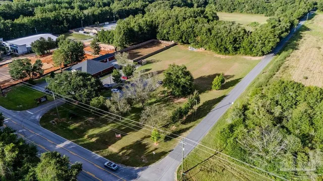 a view of yard with swimming pool and green space