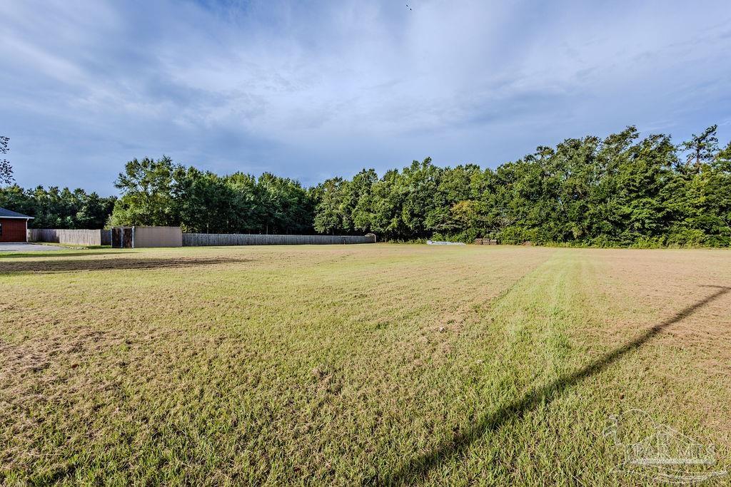Woodbine Road Pace, FL 32571 - Photo 8 of 21 a view of yard with swimming pool and green space