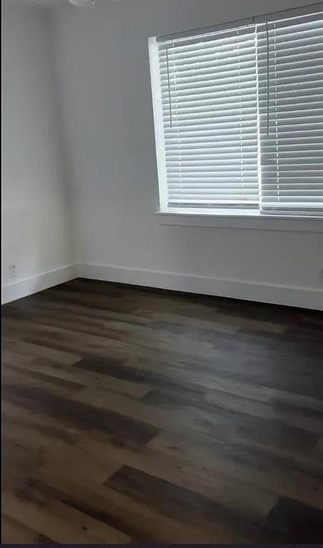 1029 Custer Road, Unit 1031 Richardson, TX 75080 - Photo 11 of 19 a view of an empty room with wooden floor and a window