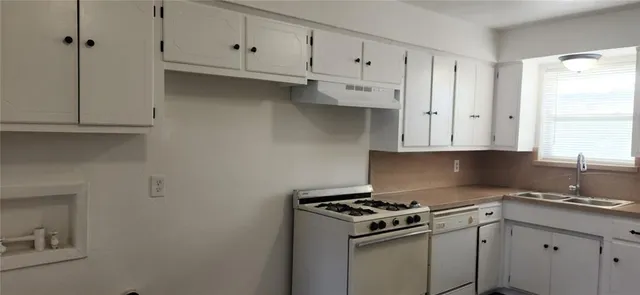a stove top oven sitting inside of a kitchen