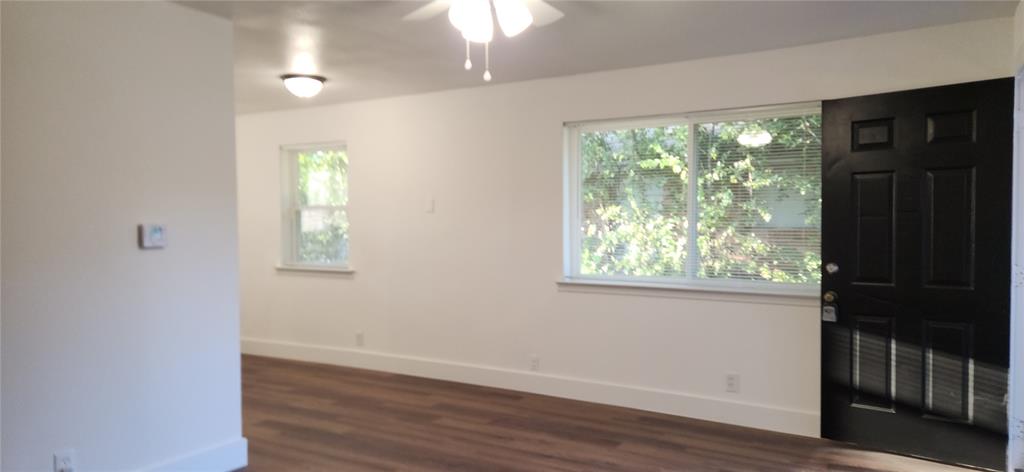 1029 Custer Road, Unit 1031 Richardson, TX 75080 - Photo 16 of 19 a view of an empty room with wooden floor and a window