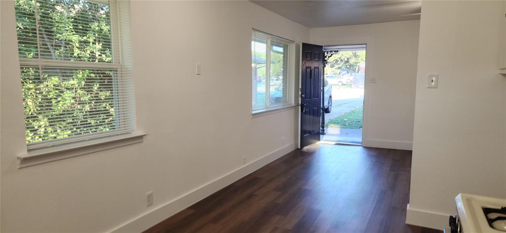 1029 Custer Road, Unit 1031 Richardson, TX 75080 - Photo 2 of 19 a view of an empty room with wooden floor and a window