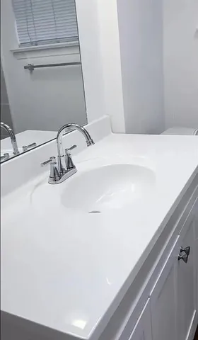 a bathroom with a sink and a mirror