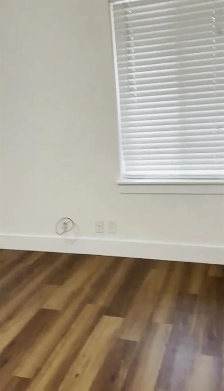 1029 Custer Road, Unit 1031 Richardson, TX 75080 - Photo 10 of 19 a view of a space with wooden floor and a window