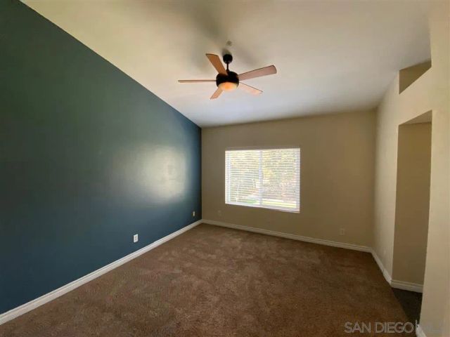 a bathroom with a granite countertop sink toilet and a mirror