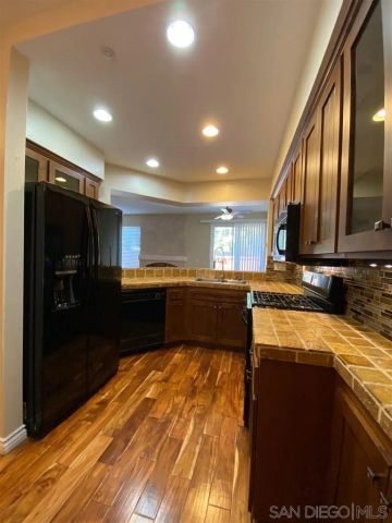 a kitchen with a sink stove top oven and cabinets