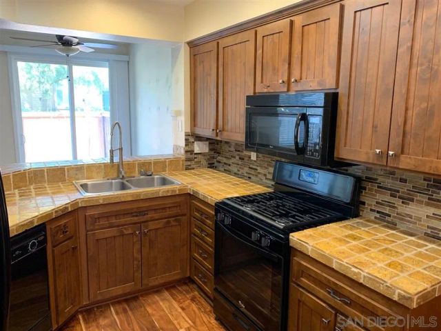 a kitchen with refrigerator and window