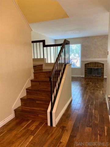 a view of a hallway with furniture and a window