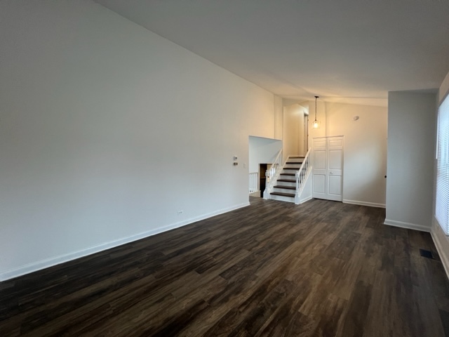 Undisclosed Address Naperville, IL 60565 - Photo 4 of 23 a view of an empty room with wooden floor and stairs