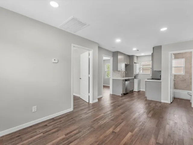 a view of a kitchen with wooden floor
