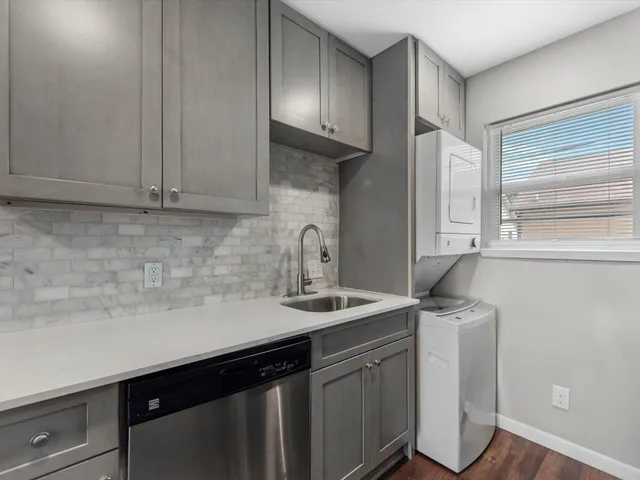 a kitchen with a sink cabinets and window