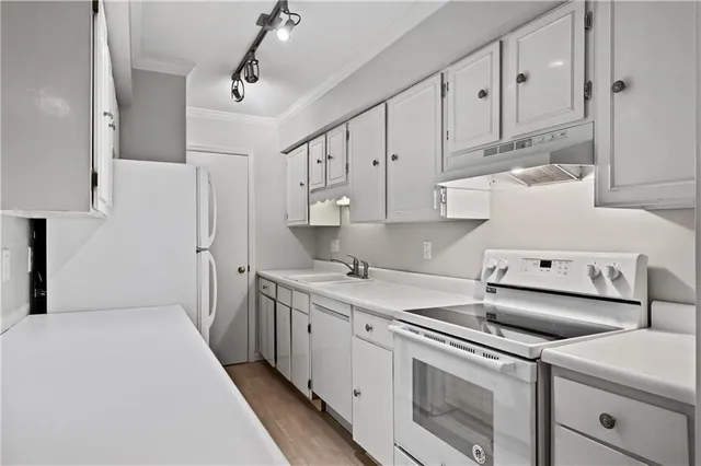 a kitchen that has a sink and a stove in it