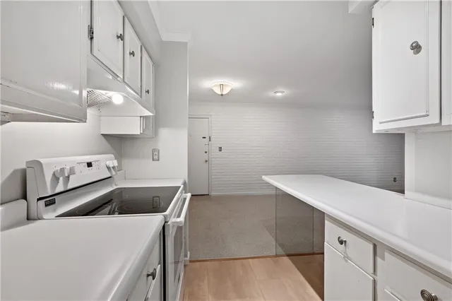 a kitchen with a sink a refrigerator and cabinets