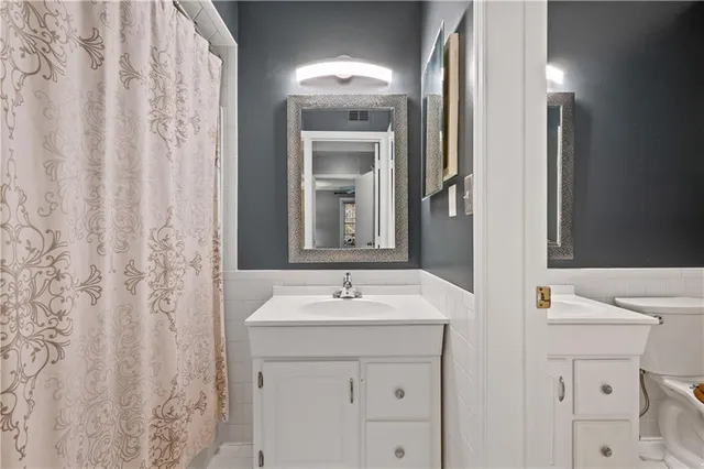a view of a balcony with wooden floor and fence