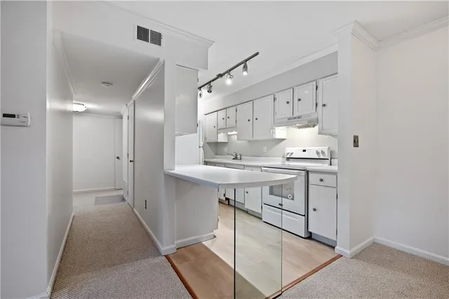 a kitchen with stainless steel appliances sink refrigerator and cabinets